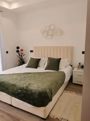 a bedroom with a large bed with a green blanket at Perfect home in Marrakech in Marrakech
