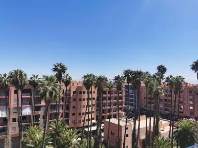 a group of palm trees in front of buildings at Perfect home in Marrakech in Marrakech