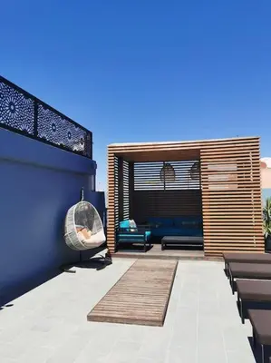 a patio with a couch and a glass orb on the wall at Perfect home in Marrakech in Marrakech