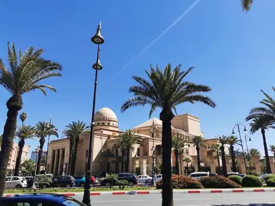 a building with palm trees in front of a street at Perfect home in Marrakech in Marrakech