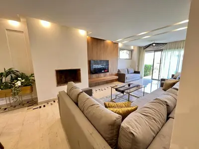 a large living room with a couch and a fireplace at Prestigia Luxury Appart 2 Room in Marrakech