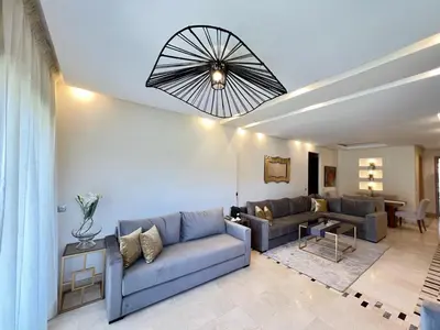 a living room with couches and a dining room at Prestigia Luxury Appart 2 Room in Marrakech