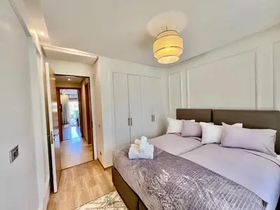 a bedroom with a large bed in a room at Prestigia Luxury Appart 2 Room in Marrakech