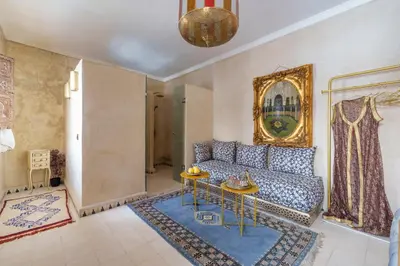 a living room with a couch and a table at Riad La Fayette Bed & Breakfast in Marrakech