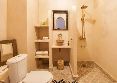 a bathroom with a white toilet and a sink at Riad La Fayette Bed & Breakfast in Marrakech