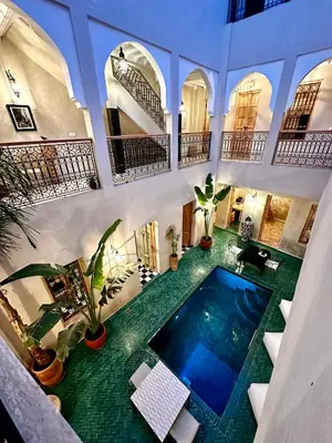 an indoor swimming pool in a building with plants at Riad Citrus By La Siredrah in Marrakech