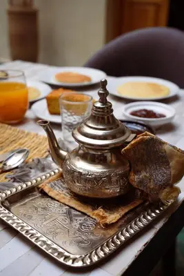 a silver tea pot on a tray on a table at Riad Citrus By La Siredrah in Marrakech