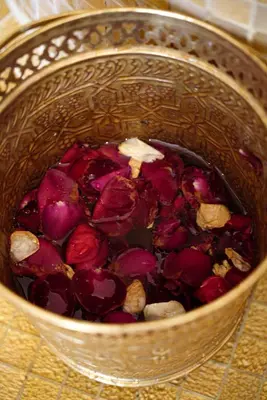 a metal bowl filled with red vegetables on a table at Riad Citrus By La Siredrah in Marrakech