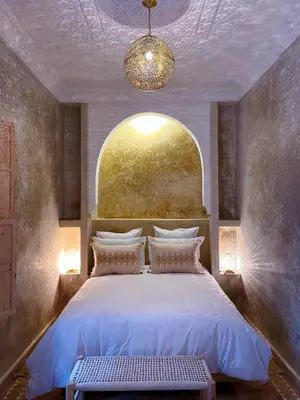 a bedroom with a large bed with a window at Riad Citrus By La Siredrah in Marrakech
