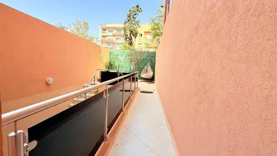 a hallway of a building next to a wall at LA FINCA DE MARRAKECH in Marrakech