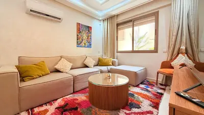 a living room with a couch and a coffee table at LA FINCA DE MARRAKECH in Marrakech