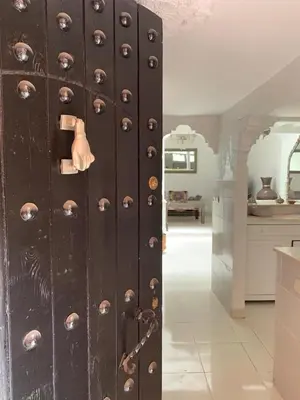 an old wooden door with rivets in a kitchen at Riad lalla aicha in Marrakech