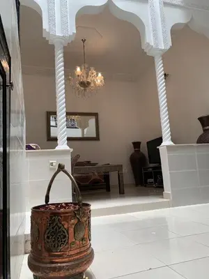 a room with a pot on the floor with a chandelier at Riad lalla aicha in Marrakech