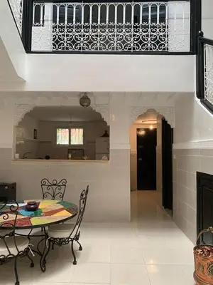 a kitchen and dining room with a table and chairs at Riad lalla aicha in Marrakech