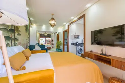 a bedroom with a large bed with a yellow blanket at Le Jasmin - Appartement Authentique à Gueliz in Marrakech