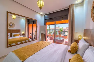a bedroom with a bed and a large mirror at Le Jasmin - Appartement Authentique à Gueliz in Marrakech