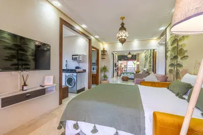 a bedroom with a large bed and a living room at L'Atlas - Appartement Authentique à Gueliz in Marrakech
