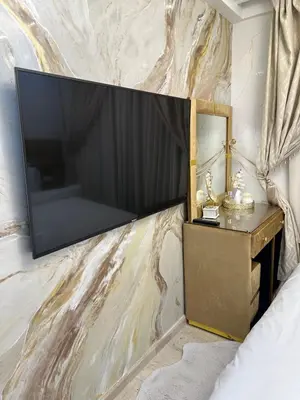 a large flat screen tv on a wall at Modern-elegant Appartement in het centrum in Marrakech