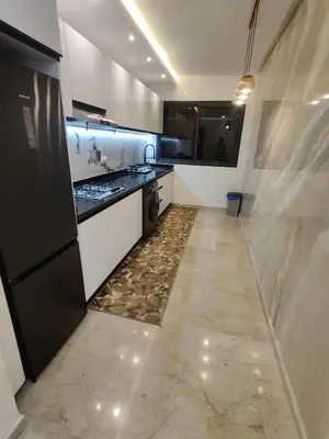 a large kitchen with a stove and a refrigerator at Modern-elegant Appartement in het centrum in Marrakech