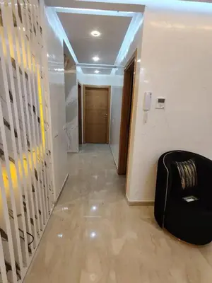 a hallway with a stair case and a room with a chair at Modern-elegant Appartement in het centrum in Marrakech