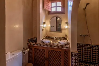 a bathroom with a sink and a mirror and a tub at Riad Anais Marrakech in Marrakech