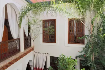 a white building with windows and plants at Riad Anais Marrakech in Marrakech