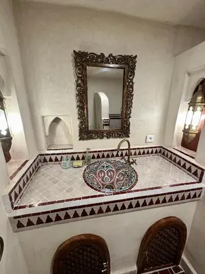 a bathroom with a sink and a mirror at Riad Sakura Marrakech in Marrakech