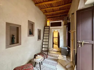 a hallway with a staircase and a room with a door at Riad Sakura Marrakech in Marrakech