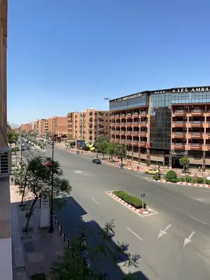 an empty street in front of a large building at Perle en plein Gueliz in Marrakech