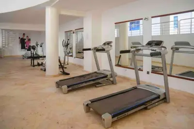a gym with treadmills and ellipticals in a room at Perle en plein Gueliz in Marrakech