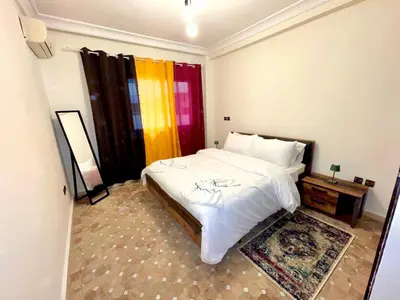 a bedroom with a bed and a colorful curtain at Perle en plein Gueliz in Marrakech