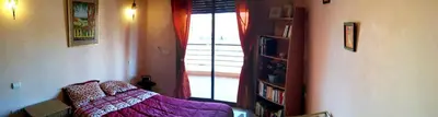 a living room with a purple bed and a window at Votre appartement d'exception in Marrakech