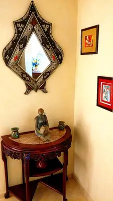 a table with a mirror on a wall at Votre appartement d'exception in Marrakech