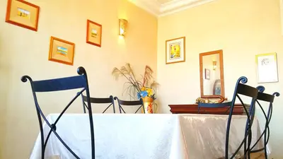 two chairs sitting at a table in a room at Votre appartement d'exception in Marrakech
