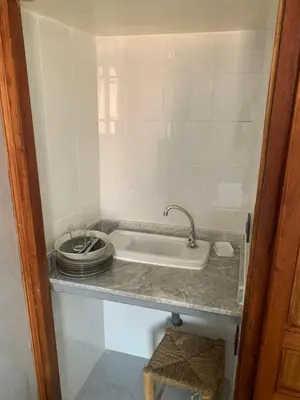 a kitchen counter with a sink and a plate at Familiale Chambre calm wifi Hanae in Marrakech