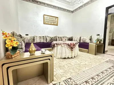 a living room with a purple couch and a table at Marrakech art in Marrakech