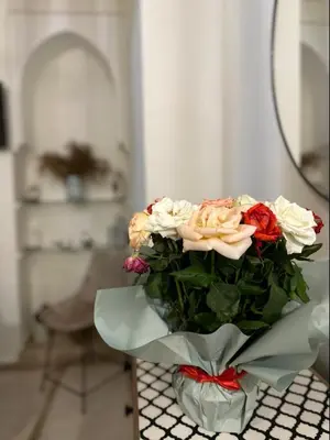 a bouquet of flowers in a vase on a table at Riad Kamilyes in Marrakech