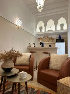 a living room with a couch and a table at Riad Kamilyes in Marrakech