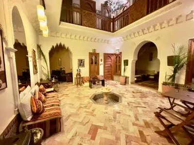 a large living room with a fountain in the middle at Riad Radia in Marrakech
