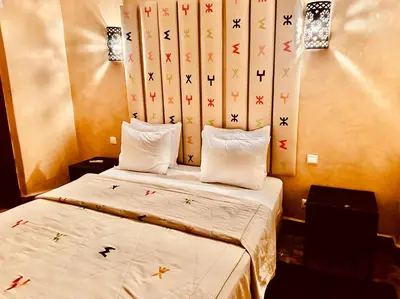 a hotel room with a bed with two pillows at Riad Radia in Marrakech