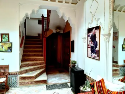 a hallway with a staircase in a house at Riad Radia in Marrakech