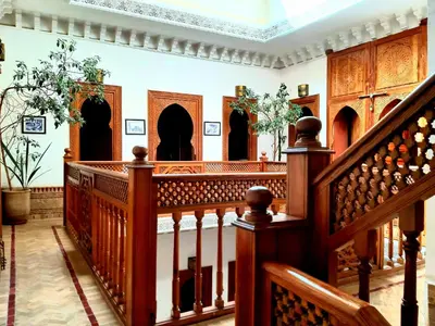 a staircase in a house with wooden railings at Riad Radia in Marrakech
