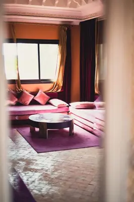 a living room with a table and a couch at Palais Jena in Marrakech