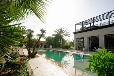 a swimming pool in front of a building at Palais Jena in Marrakech