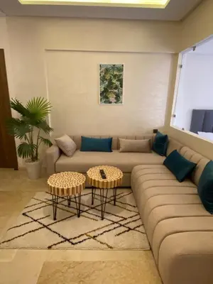 a living room with a couch and two tables at Magnifique & élégant appartement in Marrakech