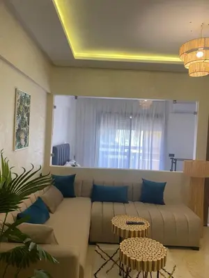 a living room with a couch and two tables at Magnifique & élégant appartement in Marrakech