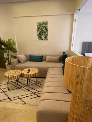 a living room with a couch and a table at Magnifique & élégant appartement in Marrakech