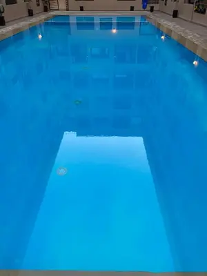 a swimming pool with blue lights on it at Magnifique & élégant appartement in Marrakech
