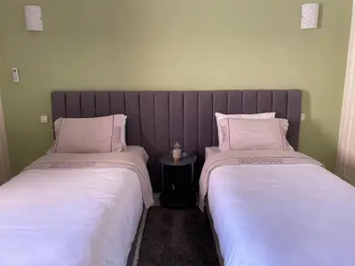 two beds sitting next to each other in a room at ☆HIVERNAGE☆ Charming , Spacious & Bright with Pool in Marrakech