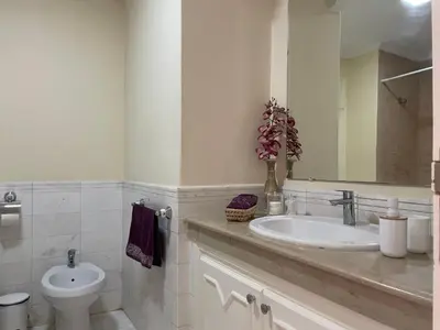 a bathroom with a sink and a toilet and a mirror at ☆HIVERNAGE☆ Charming , Spacious & Bright with Pool in Marrakech